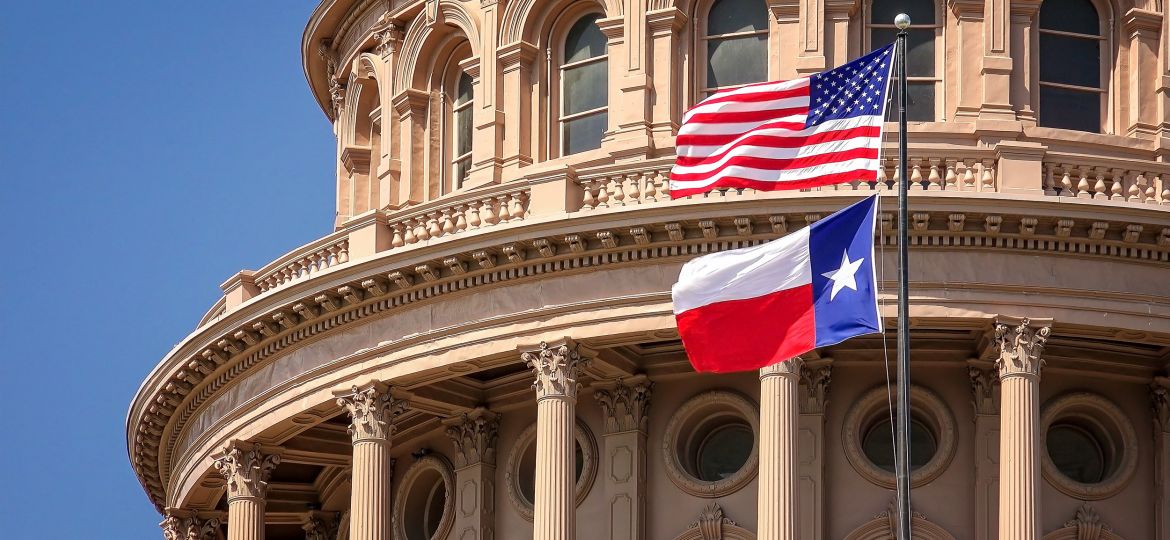 American and Texas Flags Flying at the Texas State Capitol Building in Austin