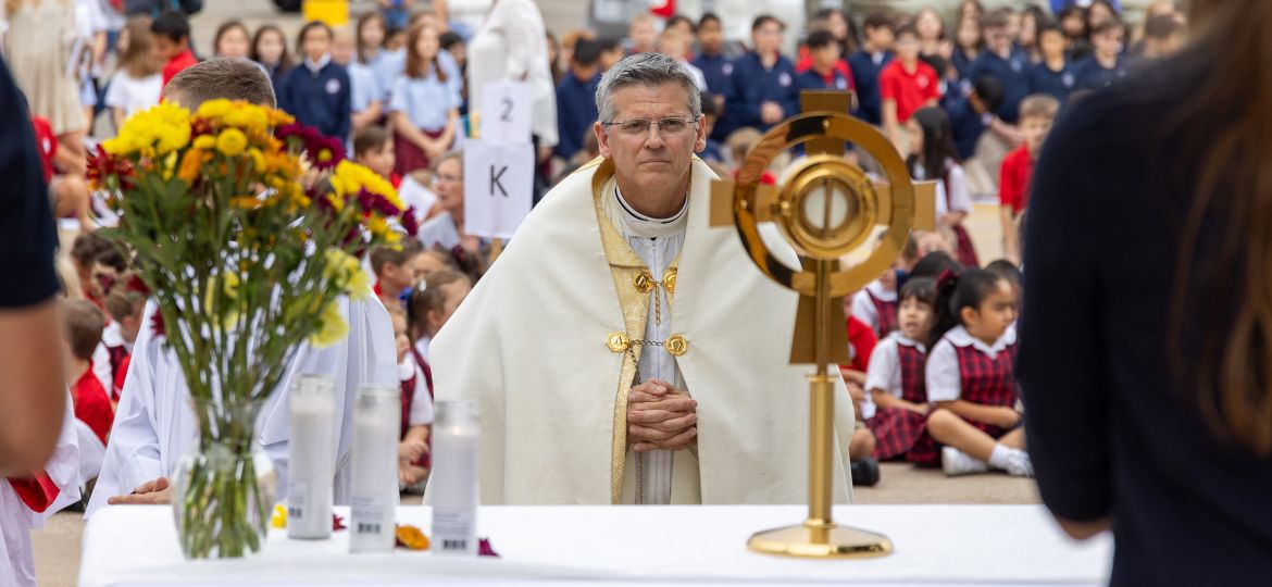 Father Alfonse Nazzaro kneels in adoration.