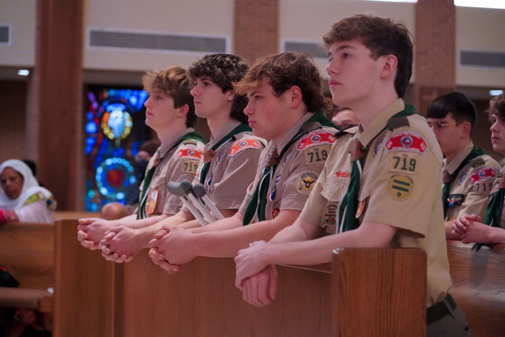 From left, Eagle Scouts Andrew Gerst, Andrew Kelton, Daniel Lucido, and Andrew Clay kneel in prayer during the Scout Sunday Mass on Feb. 4 at St. Patrick Catholic Church in Dallas. (Amy White/The Texas Catholic)