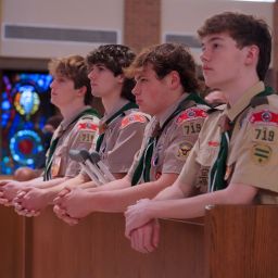 From left, Eagle Scouts Andrew Gerst, Andrew Kelton, Daniel Lucido, and Andrew Clay kneel in prayer during the Scout Sunday Mass on Feb. 4 at St. Patrick Catholic Church in Dallas. (Amy White/The Texas Catholic)