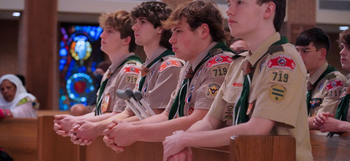 From left, Eagle Scouts Andrew Gerst, Andrew Kelton, Daniel Lucido, and Andrew Clay kneel in prayer during the Scout Sunday Mass on Feb. 4 at St. Patrick Catholic Church in Dallas. (Amy White/The Texas Catholic)