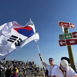 A man from South Korea waves his country's flag.