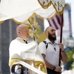 Father Roger Landry, National Eucharistic Pilgrimage chaplain, pauses to offer a blessing with the monstrance as pilgrims on the National Eucharistic Pilgrimage's Seton Route arrive for Mass at St. Patrick's Cathedral in New York City.