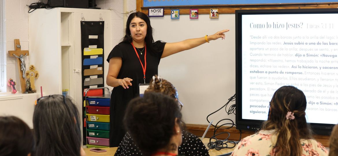 Jessica Martinez points to a presentation while presenting to participants in the Parish Ministry Conference South event at St. Cecilia Catholic Parish.