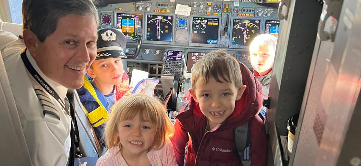 Captain Ray Simpson gives a tour of the cockpit to some of his grandchildren before a flight.