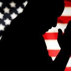 A man is pictured holding a rosary with the U.S. flag as a backdrop is silhouetted in this photo illustration. A new report released Sept. 17, 2024, by the nonpartisan More in Common research nonprofit indicates that more Americans turn to faith for spiritual support rather than political expression. (OSV News illustration/Mike Crupi, file Catholic Courier)