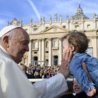 Pope Francis greets a child as he rides in the popemobile before his general audience in St. Peter's Square at the Vatican Oct. 9, 2024. (CNS photo/Vatican Media)