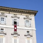 Pope Francis stands in the window of his studio in the Apostolic Palace at the Vatican as thousands of people gather below him in St. Peter's Square for the recitation of the Angelus prayer Oct. 13, 2024. (CNS photo/Vatican Media)