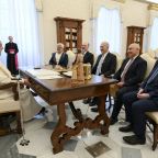 Pope Francis shares a laugh with Nasser al-Kidwa, the former Palestinian foreign minister, second from left, and Ehud Olmert, former Israeli prime minister, third from left, and their entourage in the library of the Apostolic Palace at the Vatican Oct. 17, 2024. (CNS photo/Vatican Media)