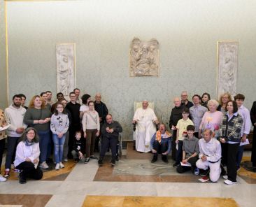 Pope Francis poses for a photo with a group of visitors experiencing homelessness and volunteers who assist them in Vienna, Austria, during an audience in the Apostolic Palace at the Vatican, Nov. 8, 2024. (CNS photo/Vatican Media)