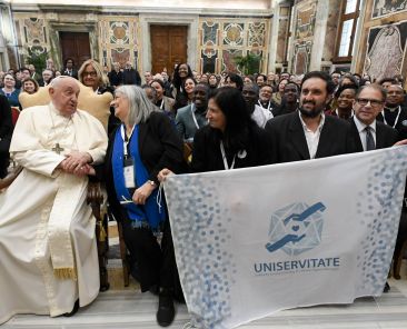 Pope Francis greets participants in a global symposium sponsored by UNISERVITATE, an organization promoting service learning in Catholic higher education, during a meeting at the Vatican Nov. 11, 2024. (CNS photo/Justin McLellan)