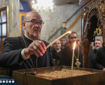 Cardinal Pierbattista Pizzaballa, Latin patriarch of Jerusalem, lights a candle in the Holy Family Parish Church in Gaza City Dec. 22, 2024. He made a pre-Christmas visit aiming to bring the joy of the season to the suffering Christian community in the 14th month of Israel-Hamas war. (OSV News photo/courtesy Latin Patriarchate of Jerusalem)