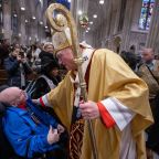 Cardinal Timothy M. Dolan greets a man after celebrating Mass at St. Patrick's Cathedral in New York City. The Dec. 29, 2024, Mass marked the kickoff of the 2025 Jubilee year, with similar celebrations taking place in diocese across the U.S. and around the world. (OSV News photo/Jeffrey Bruno)