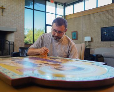 Oleh Skoropadskyi, a Ukrainian iconographer, adds last touches to his icon of Blessed János Brenner Sept. 26 during a visit to Our Lady of Dallas Cistercian Abbey in Irving, where the icon is displayed. Father Brenner, the subject of the icon, is a Hungarian Cistercian martyr whose legacy continues to inspire members of the Cistercian community in Irving. (Amy White/The Texas Catholic)