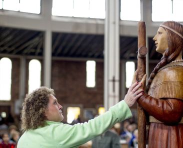 Deborah Amell touches a statue of St. Kateri Tekakwitha in 2012 at Our Lady of the Martyrs Shrine in Auriesville, New York, the site of a 17th century Mohawk village where three Jesuit missionaries were killed for their faith in and St. Kateri was born. The U.S. Conference of Catholic Bishops designated the site a national shrine Jan. 27, 2025. (OSV News photo/Jason Greene, Reuters)