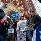 Matthew Sierra, 22, center, and Andrew Prado, 20, right, of St. Bernard Clairvaux parish, sing and dance as they chant pro life slogans before the start of this year's North Texas March for Life from the National Shrine of Our Lady of Guadalupe to City Hall in downtown Dallas, on Jan. 20, 2024.