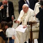 Pope Francis greets a child at the conclusion of his weekly general audience in the Paul VI Audience Hall at the Vatican Jan. 15, 2025. (CNS photo/Lola Gomez)