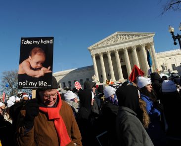 A man holds a poster outside the U.S. Supreme Court in 2014 during the March for Life in Washington. "Every Life: Cherished, Chosen, Sent" is the theme for Respect Life Month, observed in October. Respect Life Sunday is Oct. 7. (OSV News photo/Leslie Kossoff)