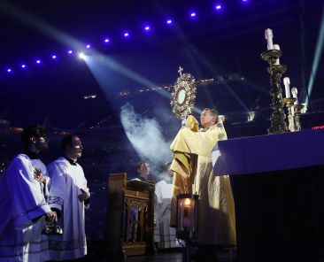 Bishop Andrew H. Cozzens of Crookston, Minn., chairman of the board of the National Eucharistic Congress Inc., blesses pilgrims July 17, 2024, during adoration at the opening revival night of the 10th National Eucharistic Congress at Lucas Oil Stadium in Indianapolis. (OSV News photo/Bob Roller)