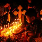 A child places a candle at the gravesite of a loved one on All Souls' Day at Wari Cemetery in Dhaka, Bangladesh, Nov. 2, 2024. As Christians continue to be the most persecuted religious group in the world, pontifical charity Aid to the Church in Need urged that Ash Wednesday and Lent 2025 shed light on the heroic witness of faith in the midst of suffering (OSV News photo/Stephan Uttom Rozario)