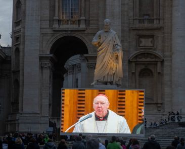 Cardinal Kevin J. Farrell, prefect of the Dicastery for Laity, the Family and Life, is seen on a video screen leading the rosary for Pope Francis at the Vatican March 10, 2025. Cardinal Farrell and other senior Vatican officials, who are on their Lenten retreat, prayed the rosary in the Vatican audience hall while people in St. Peter's Square watched on video screens. (CNS photo/Pablo Esparza)