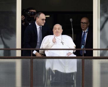 Pope Francis gives a thumbs up as he greets a crowd of well-wishers at Rome's Gemelli hospital before returning to the Vatican March 23, 2025, after 38 days of treatment at the hospital. (CNS photo/Pablo Esparza)