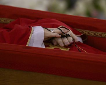 The hands of Pope Francis, holding a rosary, are seen as he lies at rest in his coffin in the chapel of his residence, the Domus Sanctae Marthae, at the Vatican April 21, 2025. (CNS photo/Vatican Media)