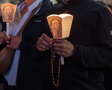Pilgrims pray during the Jubilee of the Missions nighttime recitation of the rosary in St. Peter's Square at the Vatican Oct. 4, 2025. (CNS photo/Pablo Esparza)