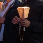 Pilgrims pray during the Jubilee of the Missions nighttime recitation of the rosary in St. Peter's Square at the Vatican Oct. 4, 2025. (CNS photo/Pablo Esparza)