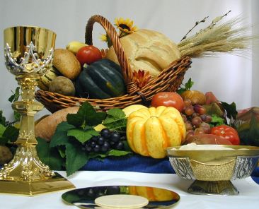 The foods of the secular Thanksgiving feast are pictured with the spiritual food of the Eucharist -- the word in Greek means gratitude or thankfulness. At Mass on Thanksgiving Day -- Nov. 27 this year -- many liturgies give special regard to spiritual and earthly sustenance. Christ gave new meaning to the bread and wine at the Last Supper with his words, "This is my body" and "This is my blood," enacting his self-gift of suffering on the cross for all people. (CNS photo illustration courtesy Southern Nebraska Register) (Nov. 19, 2003)