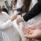 A newlywed couple holds out their wedding rings for Pope Leo XIV to bless at the end of his weekly general audience in St. Peter's Square at the Vatican Oct. 22, 2025. (CNS photo/Vatican Media)