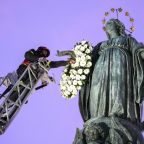 Roberto Leo, a senior firefighter, places a wreath of flowers on a Marian statue near the Spanish Steps in Rome Dec. 8, 2025, the feast of the Immaculate Conception. (CNS photo/Lola Gomez)