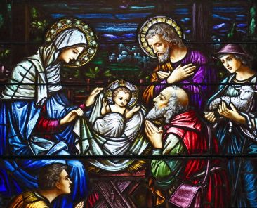 This stained-glass window at St. Aloysius Church in Great Neck, N.Y., depicts Jesus in a manger surrounded by Mary, Joseph and three shepherds. (OSV News photo/Gregory A. Shemitz)