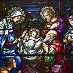 This stained-glass window at St. Aloysius Church in Great Neck, N.Y., depicts Jesus in a manger surrounded by Mary, Joseph and three shepherds. (OSV News photo/Gregory A. Shemitz)