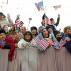 Visitors from California wave U.S. flags as they cheer for Pope Leo XIV in St. Peter’s Square at the Vatican before his weekly general audience Dec. 10, 2025. (CNS photo/Lola Gomez)