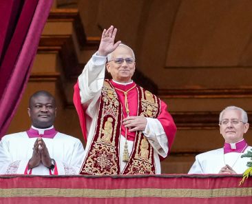 Pope Leo XIV waves to visitors gathered in St. Peter’s Square after delivering his Christmas message and blessing "urbi et orbi" (to the city and the world) from the central balcony of St. Peter's Basilica at the Vatican Dec. 25, 2025. (CNS photo/Lola Gomez)