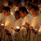 Priests hold candles as they wait for Pope Francis to arrive for Mass with consecrated women and men marking the feast of the Presentation of the Lord and the World Day for Consecrated Life in St. Peter's Basilica at the Vatican Feb. 2, 2018. (CNS photo/Max Rossi, Reuters)