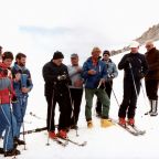In this 1984 file photo, St. John Paul II, in a black ski jacket and hat, prays with a group of skiers before heading down a slope in Italy in 1984. The pontiff, who had enjoyed skiing in his native Poland, slipped away to ski a number of times while he led the worldwide church. (CNS photo/Arturo Mari, L'Osservatore Romano)