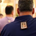 Men are seen in a file photo wearing scapulars during a Mass marking the feast of Our Lady of Mount Carmel at the Pontifical Shrine of Our Lady of Mount Carmel in East Harlem, N.Y. Wearing a Miraculous Medal or scapular in any of its various colors indirectly recalls the time-honored apparitions of the Virgin Mary in which these sacramentals find their origins. (OSV News photo/Gregory A. Shemitz)