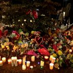A woman pays tribute at a makeshift memorial Feb. 11, 2026, the day after a deadly mass shooting at Tumbler Ridge Secondary School in British Columbia. An 18-year-old suspect opened fire at the school Feb. 10, killing at least eight people and wounding dozens more. Police said the suspect was found dead inside the school with a self-inflicted injury. (OSV News photo/Jennifer Gauthier, Reuters)