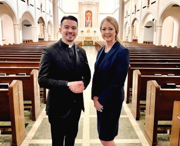 Father Ryan Hiaeshutter, left, pastoral administrator of St. Thomas Aquinas Catholic Parish, announced Jan. 17 that Lisa Long would be the next president of St. Thomas Aquinas Catholic School. Long, who currently serves as the principal at Christ the King Catholic School, will step into her new role in the 2026-2027 school year.