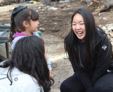University of San Diego students and a young resident of Albergue Las Memorias in Mexico laugh together during "Tijuana Spring Breakthrough," an alternative spring break experience sponsored by the university's ministry. (CNS photo/University of San Diego) See USD-SPRING-BREAK March 20, 2019.