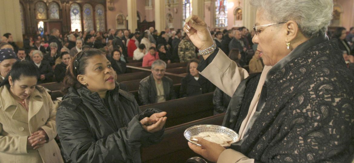 WOMAN DISTRIBUTES COMMUNION