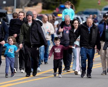 Parents are escorted by police down a road back to their cars after being reunited with their children after a suspect crashed his truck into the hallway of Temple Israel synagogue in West Bloomfield, Mich., March 12, 2026. An attacker armed with a rifle was fatally shot after ramming his vehicle into one of the nation's largest Reform synagogues in what federal investigators said was an act of violence targeting the Jewish community. (OSV News photo/Eric Seals, USA Today Network via Reuters) Editors: NO RESALES. NO ARCHIVES. THIS IMAGE HAS BEEN SUPPLIED BY A THIRD PARTY