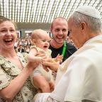 Pope Leo XIV greets a baby and family at the conclusion of his weekly general audience in the Paul VI Audience Hall at the Vatican Aug. 27, 2025. (CNS photo/Vatican Media)