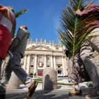 People carrying palm fronds and olive branches join a procession near St. Peter’s Basilica as Pope Leo XIV celebrates Palm Sunday Mass in St. Peter’s Square at the Vatican March 29, 2026. (CNS photo/Lola Gomez)