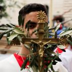 A server carries a cross adorned with leaves during a procession as Palestinian Christians attend a Palm Sunday Mass at Holy Family Church, in Gaza City, March 29, 2026. (OSV News/Dawoud Abu Alkas, Reuters)