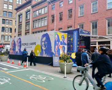 A bicyclist passes Catholic Charities USA's People of Hope Museum March 26, 2026, just north of Union Square in Manhattan. The tractor-trailer-sized traveling museum will tour the country highlighting "the impact of neighbors helping neighbors, and celebrating the power of Christian service," organizers said. (OSV News photo/Armando Machado, The Good Newsroom)
