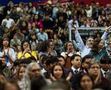Catholics wave to Bishop Edward J. Burns as parishes are recognized during the celebration of the 40th Anniversary of the Neocatechumenal Way, on March 1, 2026 at Mood Coliseum on the campus of SMU in Dallas. Bishop Burns will offered words of welcome, presided over evening prayers, and shared a homily during the celebration.