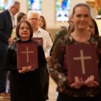Ministers from across the diocese carry the Books of the Elect for Bishop Edward Burns to accept and sign during the Rite of Election Mass, on Feb. 21, 2026 at the National Shrine Cathedral of Our Lady of Guadalupe in Dallas.